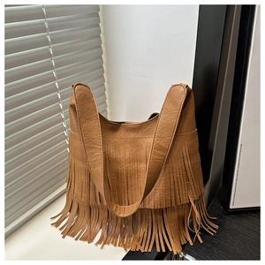 Close-up of caramel bohemian crossbody bag with long double-layer tassel details
