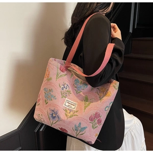 Close-up of pink floral jacquard tote bag with embroidered flowers and fabric strap