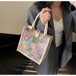 Detailed shot of mini linen floral tote bag with wooden button and white rope handle