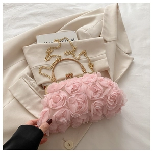 Dettaglio dei petali di rosa 3D rosa e del manico in metallo dorato sulla borsa di lusso