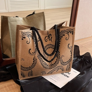 Large linen tote bag with vintage vine print and black handles for fashion or travel