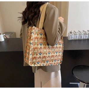 Detail of bohemian canvas tote bag showing colorful geometric pattern and wide strap