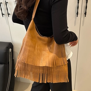 Retro brown hobo shoulder bag with stylish fringe tassels and minimalist curved design