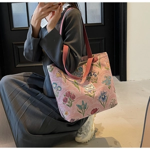 Detail of the large pink floral canvas tote bag showing its spacious capacity and print