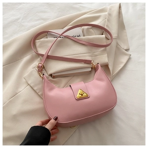Detailed view of pink crescent bag with golden triangle clasp and adjustable strap