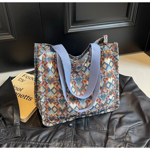 Close-up of bohemian tote bag featuring colorful geometric patterns and woven texture