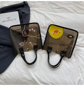 Détail de sacs cabas en PVC transparent avec d'adorables illustrations d'ours et de canard