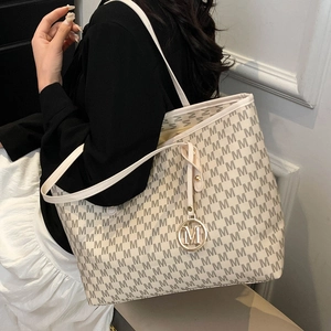 Chic off-white monogram tote bag with all-over M-letter print and top handle for commute