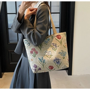 Close-up of floral jacquard canvas fabric texture and woven handles on the tote bag