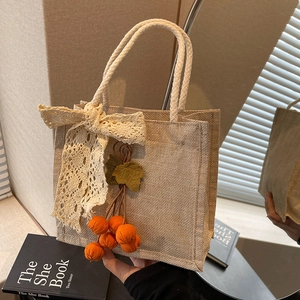 Retro woven linen lunch handbag with cream lace bow and orange pendant decoration