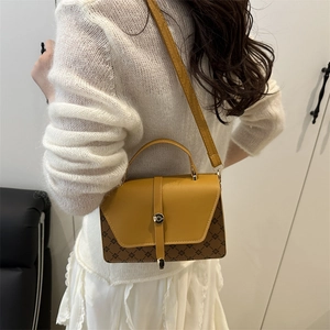 Ginger yellow monogram leather crossbody bag with adjustable strap worn by model