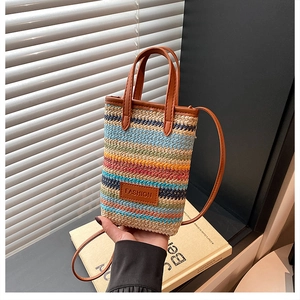 Detail of multi-colored woven bag with striped texture and a leather fashion tag