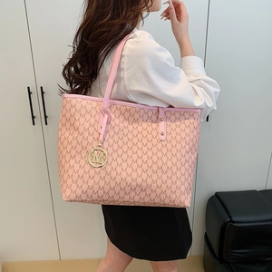 Pink quilted tote bag with letter M monogram pattern and gold charm accessory