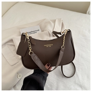 Detail of dark brown lychee texture bag with gold chain and dual shoulder straps