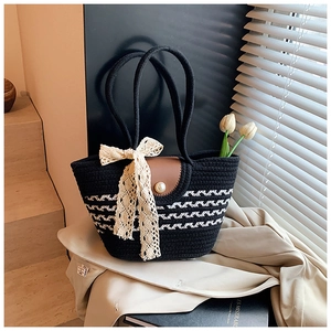 Detail of woven tote bag with white wavy texture, pearl button and lace ribbon accent