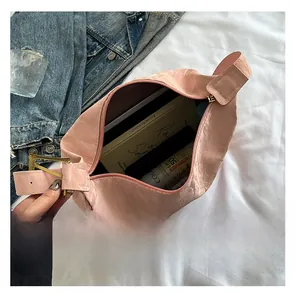 Detail showing the spacious interior of pink pleated tote bag with golden metal buckle