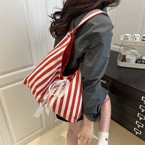 Red and white striped tote bag with elegant white lace bow and adjustable shoulder strap