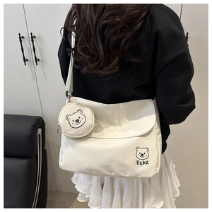 Detail view of the cream white crossbody bag with cute bear print and round coin pouch