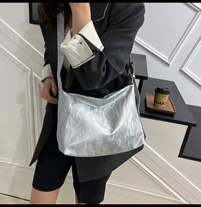 Detail of silver metallic wrinkled tote bag showing texture and high-capacity design