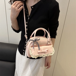 Pink lace crossbody bag for women featuring bow detail and elegant floral outfit look