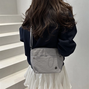 Japanese style gray canvas crossbody bag with nylon texture and minimalist strap design