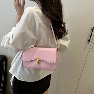 Chic pink shoulder bag for women featuring a wave-edge flap and golden metal clasp
