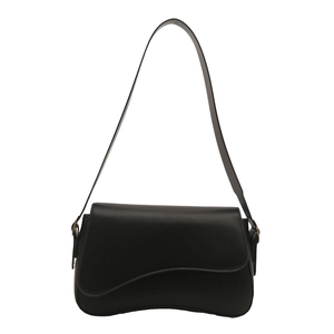 Minimalist black leather shoulder bag with unique asymmetrical wave flap and metal hardware