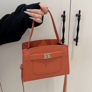 Large orange crossgrain leather handbag with metal twist lock and shoulder strap
