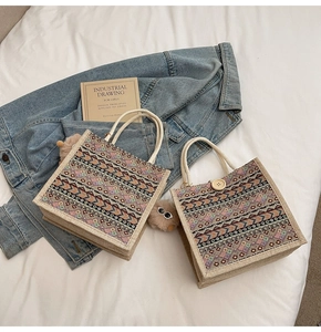 Detail of ethnic geometric patterned tote bags in coarse linen texture with cotton rope handles