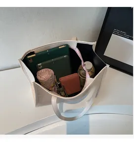 Top view of spacious interior of cream tote bag showing capacity for daily essentials