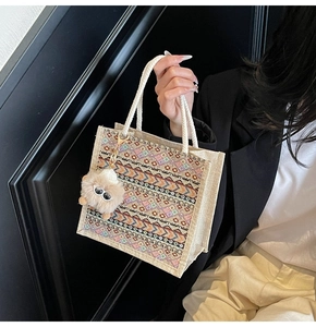 Ethnic jute tote bag with geometric patterns and plush charm for casual shoulder wear