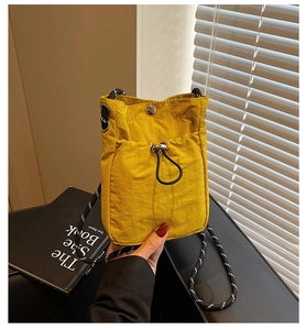 Yellow nylon phone bag featuring drawstring front pocket and striped rope shoulder strap