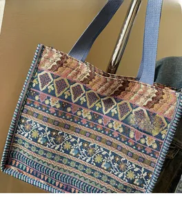 Close-up of bohemian woven tote bag showing detailed ethnic floral jacquard patterns
