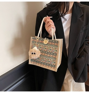 Detailed shot of ethnic pattern tote bag with cotton rope handles and plush charm accessory