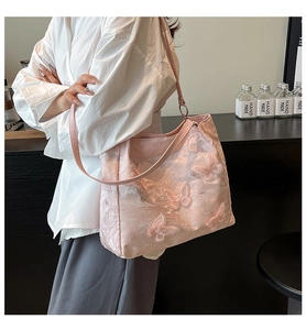 Close-up of pink jacquard tote bag with 3D butterfly embroidery and fine shoulder strap