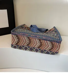Close-up of bohemian woven tote bag showing blue geometric jacquard fabric and strong handles