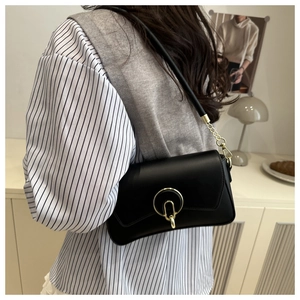 Detail showing matte PU leather black crossbody bag with gold round decorative buckle