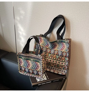 Close-up of ethnic jacquard tote bags with colorful geometric patterns on a black sofa