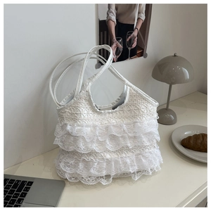 Detail of white lace tote bag with tiered ruffles against an elegant lifestyle background