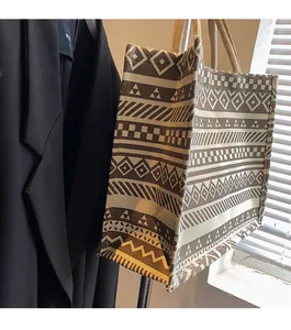 Detail of bohemian geometric print tote bag with thick rope handles and textured jute fabric