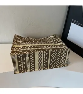 Macro view of geometric pattern canvas tote bag with brown and beige ethnic prints