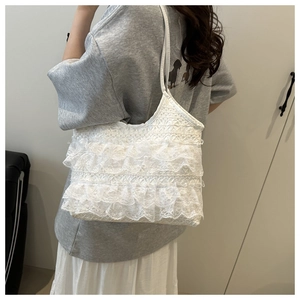 Detailed view of layered lace ruffles and mesh texture on the white aesthetic tote bag