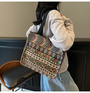 Detailed close-up of Bohemian tote bag featuring intricate ethnic floral embroidery patterns