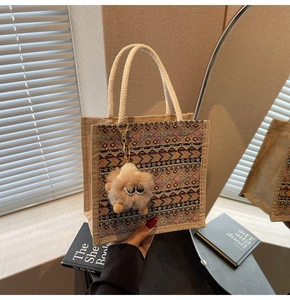 Detailed texture of ethnic woven pattern on a jute tote bag with rope handle