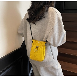 Detail of yellow waterproof nylon phone bag with drawstring pocket and snap button