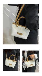 Detail showing white woven bucket bag with brown leather straps and fashion label tag