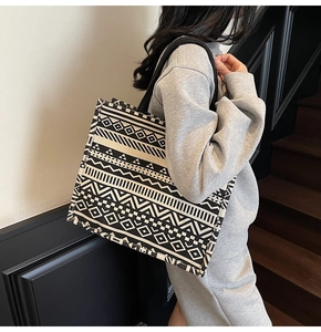 Detailed view of large canvas tote bag with black and white geometric ethnic patterns