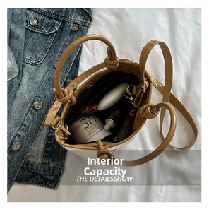 Internal capacity of the straw bucket bag showing cosmetics and daily essentials