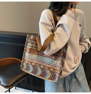 Detailed close-up of bohemian jacquard tote bag with geometric patterns on model