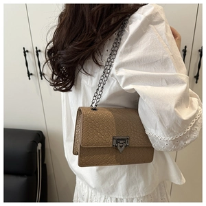 Chic khaki faux crocodile texture bag with V-shaped metal lock and chain strap on model